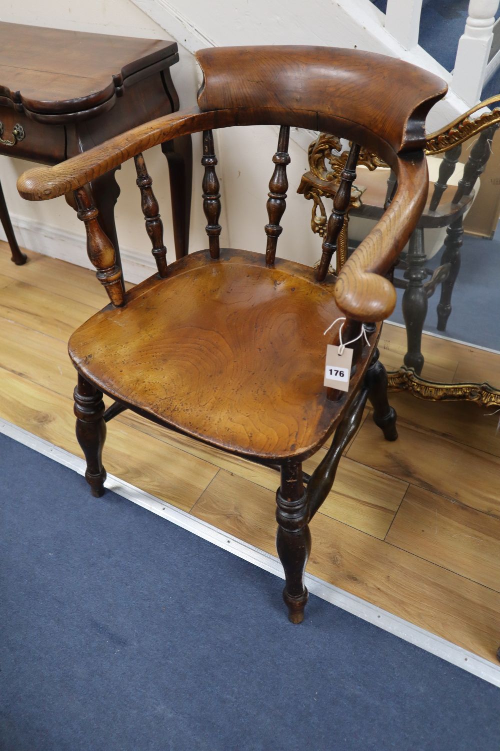 A Victorian ash and elm smokers bow armchair